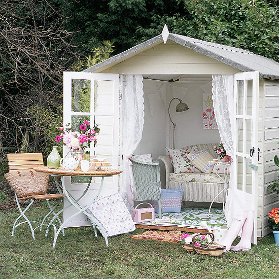 small white shed with open doors and shabby chic style decorations