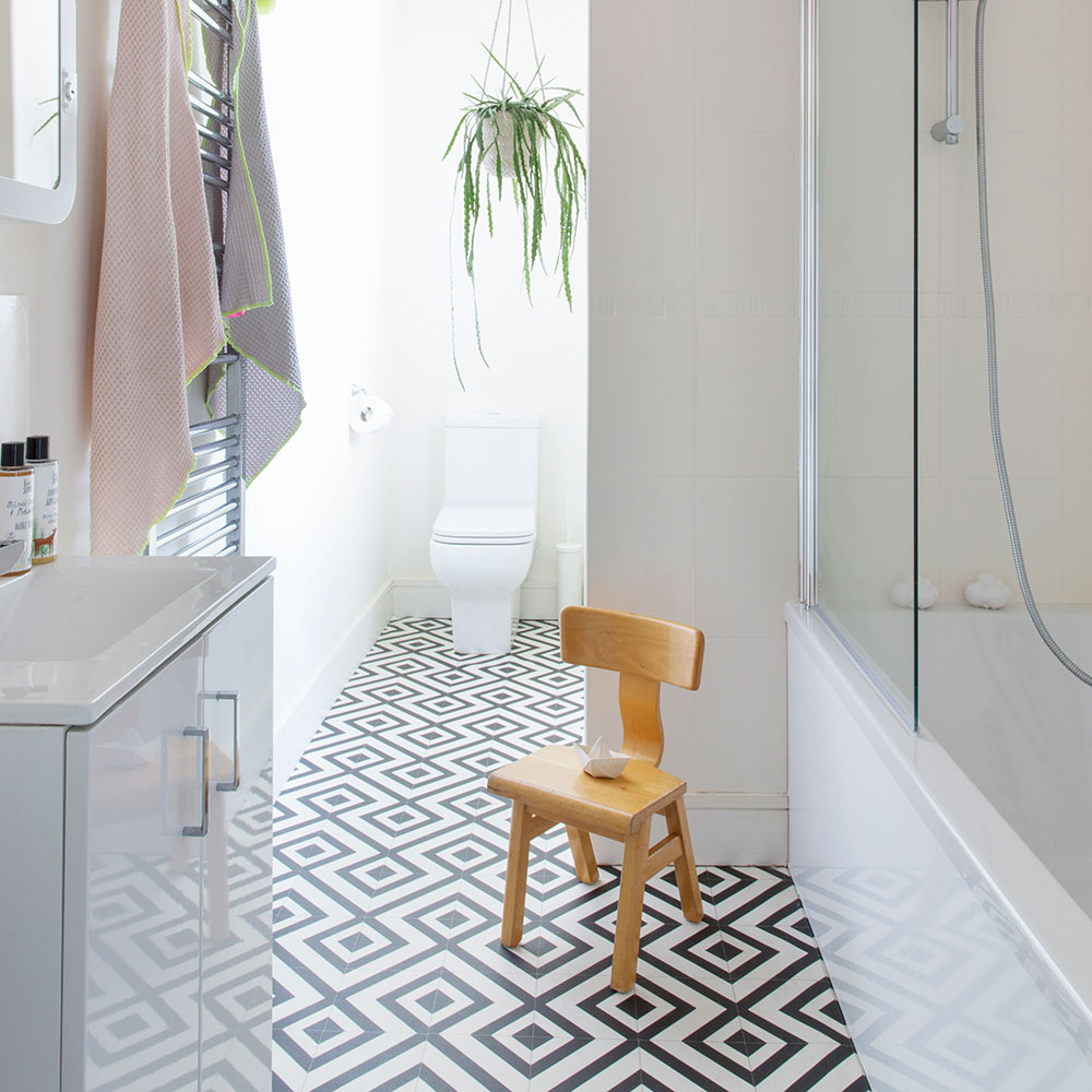 Modern monochrome bathroom with geometric vinyl floor tiles